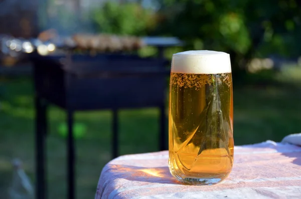 Glass of amber beer to kebabs — Stock Photo, Image