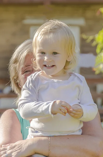 Little girl at the hands of his grandmother — Stock Photo, Image