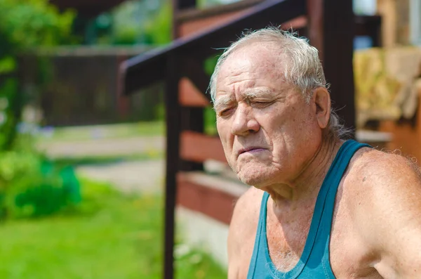 Elderly Man Green Shirt Sits Country House His Eyes Closed — Stock Photo, Image