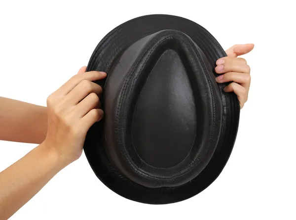 Черная шляпа на руках — стоковое фото