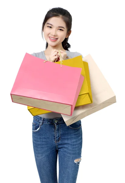 美しいアジア系の女の子が白い背景で買い物やバッグを持って — ストック写真