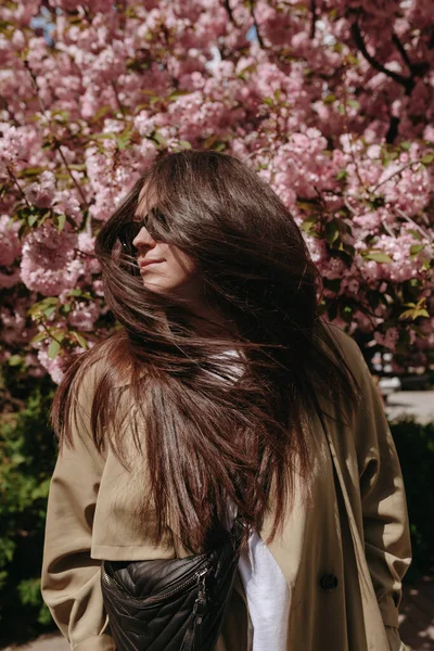Portrait Pretty Woman Flying Long Brown Hair Sunglasses Blossomed Tree — стоковое фото