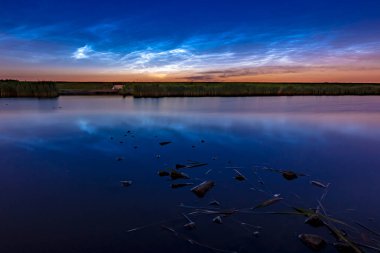 Noctilucent clouds also polar mesospheric clouds or night shining clouds reflection in water