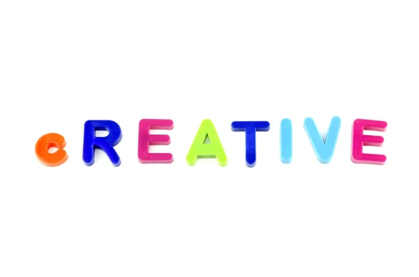 Wort kreativ aus Plastikspielzeug Buchstaben — Stockfoto