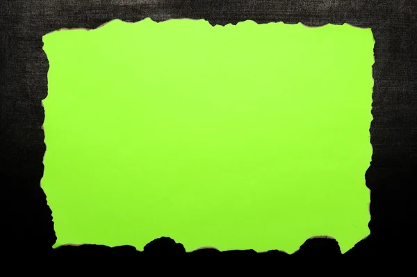 Green burnt paper on chalkboard — Stock Photo, Image