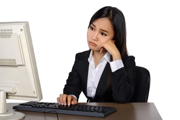 Business woman is looking stressed as she works at her computer — Stock Photo, Image