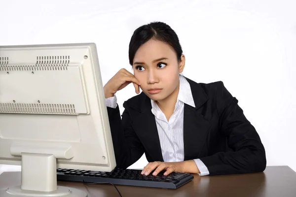 Business woman is looking stressed as she works at her computer — Stock Photo, Image