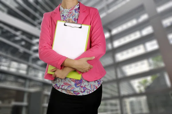 Businesswoman holding clipboard in meeting room — Stock Photo, Image