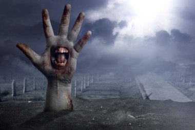Zombi elleri avucunda mezarlıktan yükselen bir ağızla.