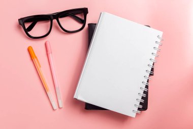 Note book with a pen with colored background