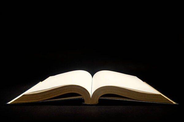 Closeup view of the opened book with dark background