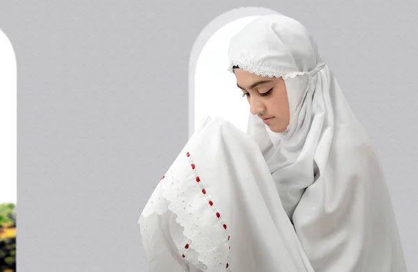 立ち上がりながら手を上げ モスクで祈りながらベールに身を包んだアジア系ムスリム女性 — ストック写真