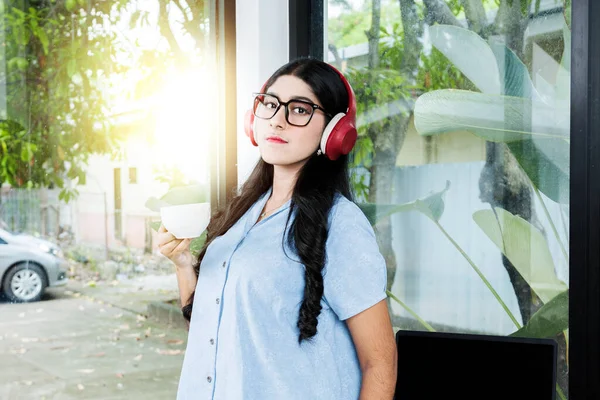 Asian Woman Eyeglass Listening Music Headphones Holding Cup Coffee Laptop — Stock Photo, Image