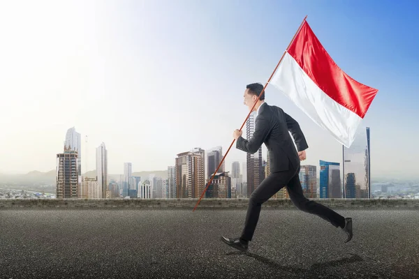 Asian Businessman Running While Carrying Indonesian Flag Blue Sky Background — Stock Photo, Image