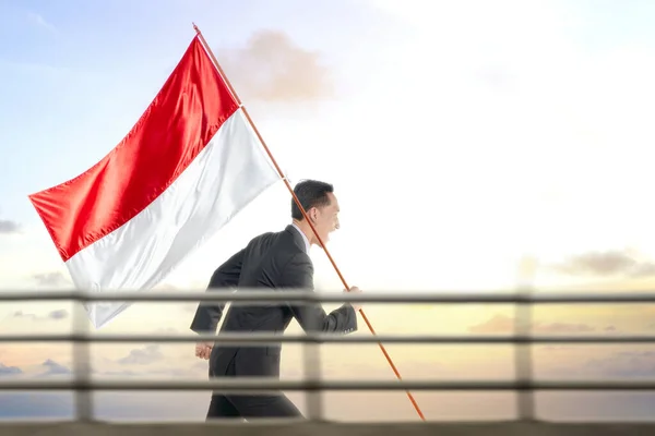 Asian Businessman Running While Carrying Indonesian Flag Blue Sky Background — Stock Photo, Image