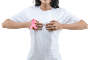 A woman in a white shirt shows a pink awareness ribbon isolated over white background. Breast cancer awareness