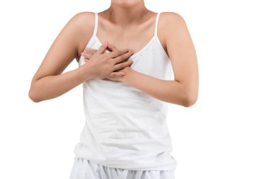 The woman in a white shirt holding her breast isolated over white background. Breast cancer awareness
