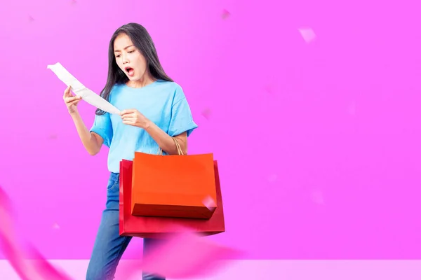 Asian Woman Shocked Looking Bill While Carrying Shopping Bag Colored — Stock fotografie