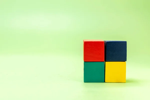Stacks of colorful wooden block toys on a colored background