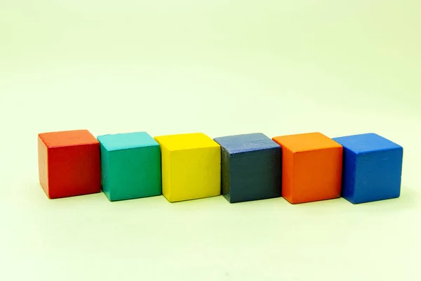 Colorful wooden block toys on a colored background