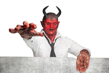 Devilman standing behind the wall isolated over white background. Halloween concept