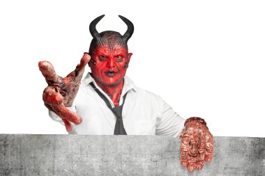 Devilman standing behind the wall isolated over white background. Halloween concept
