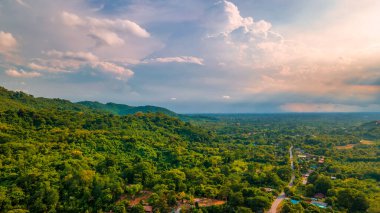 Photograph of beautiful countryside green tree forrest landscape. Mountain hill as blue background. Aerial photograph. Saraburi