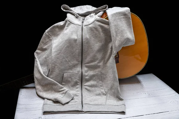 A Unisex grey coloured hoodie with front pockets and hood and full zip up the front of the garment