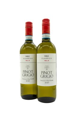 Irvine, Scotland, UK - December 13, 2021: Two Bottles of M&S branded Classics No.4 Pinot Grigio white wine in a green coloured glass bottle with labels and red metal top and seal.