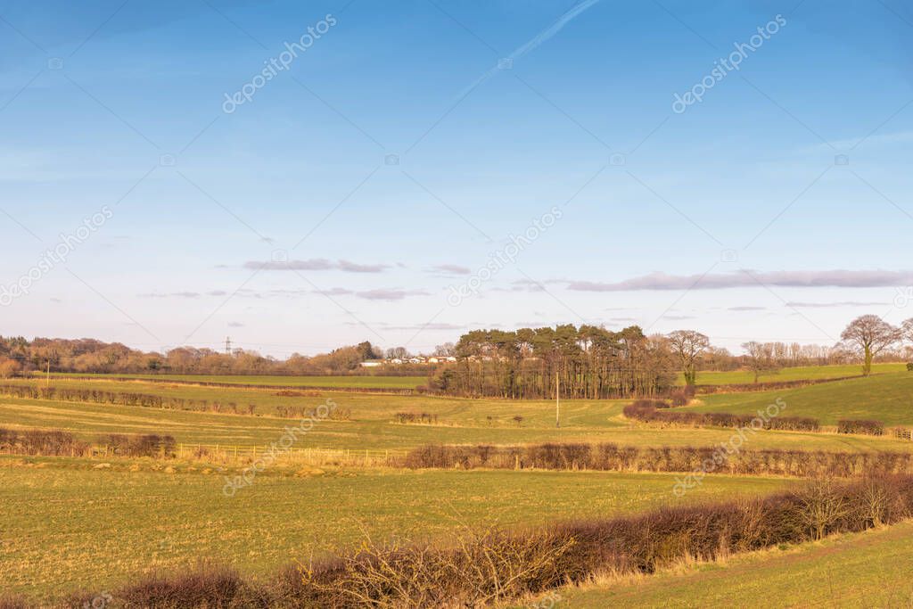 Irvine, Scotland, UK - March 06, 2022: Beautiful Scottish Farmlands of Perceton Mains with Cunninghame Head retirement village reflecting evining light Irvine Scotland.