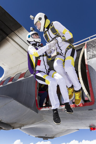 Skydivers jumping out of airplane