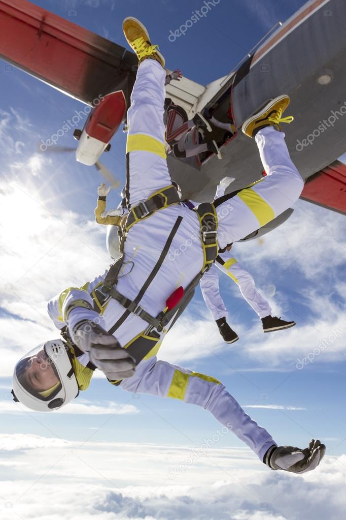 Skydivers jumping out of airplane