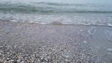 Deniz kıyısında sakin bir hava var. Boş bir sahilde dalgalar, yakın plan.,