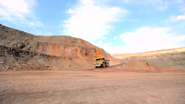 Large mining dump truck. Large dump truck in a coal mine. Yellow dump truck in a coal mine. The dump truck drives through the quarry. — Stock Video