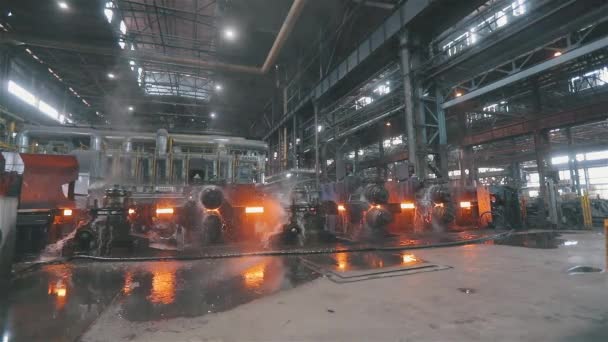 Hot metal on a conveyor line. Red hot metal. Production of rolled metal at a metallurgical factory — Stock Video