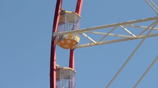 Ferris wheel cabin on the background of blue sky. Ferris wheel close up — Stock Video