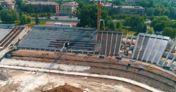 Construction site of the new stadium top view. Construction of a new modern stadium from above. Construction of a sports complex. — Stockvideo
