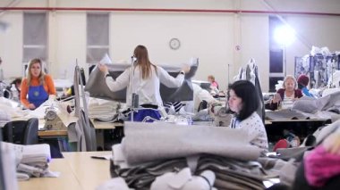 Tekstil fabrikasında çalışma süreci. Kadınlar dikiş atölyesinde çalışıyor. Modern tekstil fabrikası