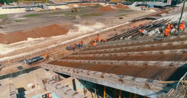 Builders are building a stadium top view. Construction site. Creation of metal structures during the construction of a stadium — Video Stock