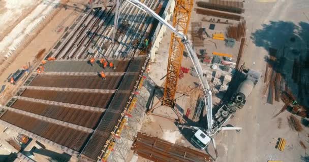 Builders are building a stadium top view. Construction site. Creation of metal structures during the construction of a stadium — Stockvideo