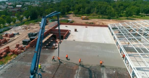 Construction site from the air. workers are pouring concrete over the floor of the building. Construction site view from the drone. Formwork creation — Stock Video