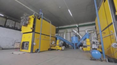 The stove runs on waste from woodworking. Wood sawdust heating stove. Wood sawdust boiler. Industrial stove working on waste from woodworking.