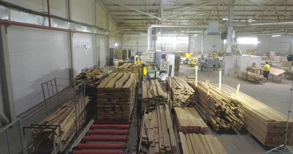 Furniture production workshop. People work in the shop. Workshop for the production of furniture boards. Industrial interior.