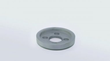 The steel Washer rotates against a white background. Iron puck isolated