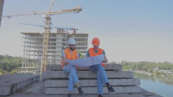 Engineers on the background of construction site funny frame. Comic shot engineers cross their legs. — Stok Video