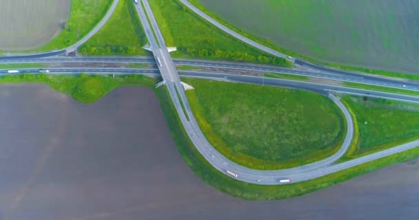 Velká silnice s auty top view za pěkného počasí. Auta jezdí po dálnici za městem. Přepravní výměna na dálnici. — Stock video