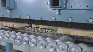 Taşıyıcı hat üzerinde ahşap boşlukları işliyor. Modern üretimde otomatikleştirilmiş üretim hattı
