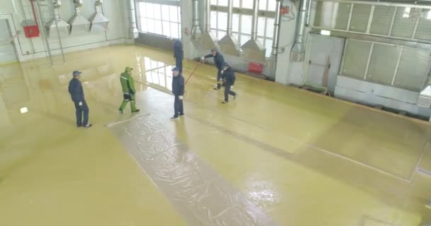 Självutjämnande golv över ett stort område. Byggare gör en självutjämnande golv i fabriken workshop.Self-utjämning golv i verkstaden — Stockvideo