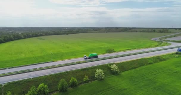 A fuel truck drives along the highway, top view. The fuel truck is driving along the road, view from the drone. — Stock Video