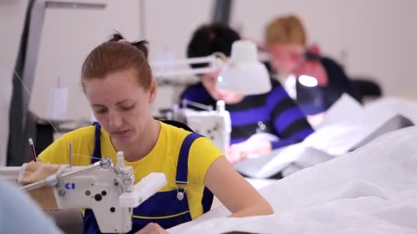 Una costurera trabaja en una fábrica de costura. producción de costura. Producción textil para el hogar. Gran taller de costura — Vídeo de stock